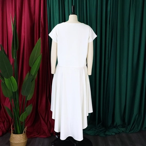 Detail of white two-piece set featuring short-sleeve top and long flowing maxi skirt