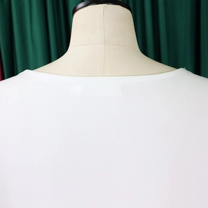 Detail of a white round neck knitted top showing high-quality fabric on a beige mannequin