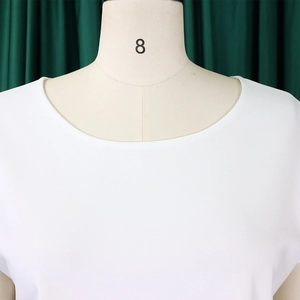 Close-up of white crew neck chiffon blouse with smooth texture on a mannequin