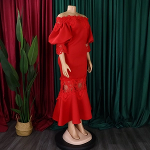 Detail of off-shoulder neckline with delicate lace and puffed sleeves on red fishtail dress