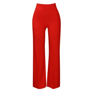 Detail view of high-waist red wide-leg trousers showing sleek draping fabric