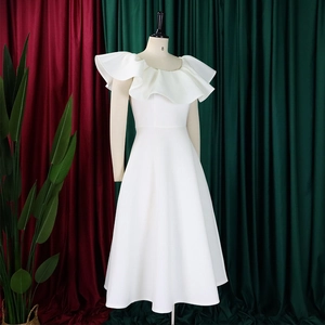 Détail du décolleté à volants élégants et du tissu fluide de la robe de soirée blanche