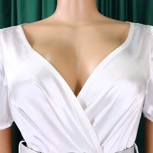 Detailed view of white satin fabric texture and elegant V-neck design for women's dress