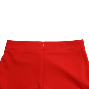 Detail of high waisted wide leg pants with hidden back zipper and smooth red woven fabric