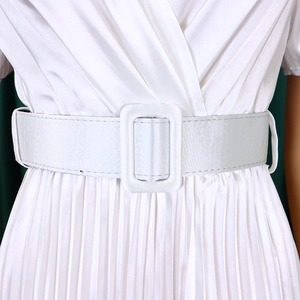 Close-up of a white V-neck satin dress showing the pleated skirt and a buckled waist belt