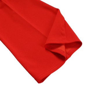 Detailed close-up of the red high-waisted wide-leg trousers showing neat hem stitching