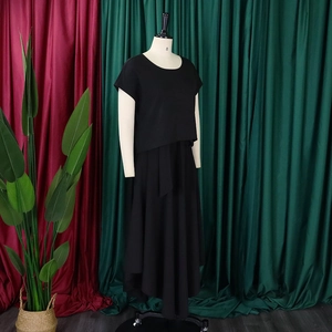 Detail of plus size black two-piece set featuring short sleeve top and high-waist maxi skirt