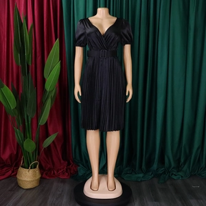 Detail of black V-neck pleated dress with satin finish and matching square buckle waist belt