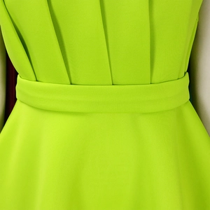 Detail of high waist pleats and matching belt on this neon green evening party dress