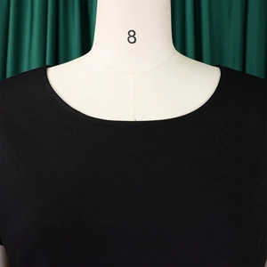 Detail of the high-quality stitching and round neckline on a black knit top
