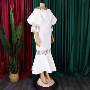 Detail of white off-shoulder gown with floral lace bubble sleeves and fishtail hemline