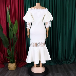 Detail of off-shoulder lace dress featuring puffed sleeves and ruffled mermaid hemline