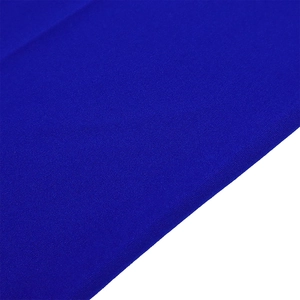 Detail of royal blue wide-leg pants fabric showing premium matte texture and fine weave