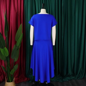 Rear view of royal blue two-piece maxi skirt set with asymmetrical hem on mannequin