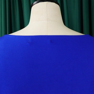 Detail shot of the royal blue boat neckline and textured knit fabric of this plus-size top