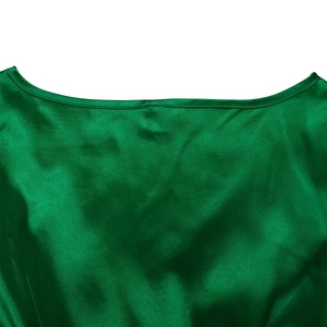 Close-up of boat neckline and fine stitching on emerald green satin dress