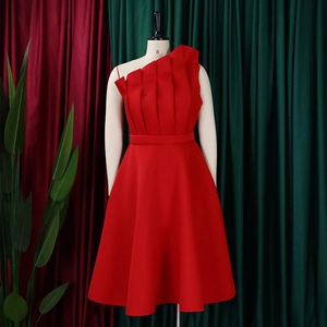 Detail of elegant red one-shoulder dress with layered vertical ruffles on the waist