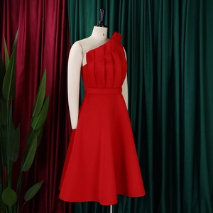 Detail of red one-shoulder dress with vertical pleats and high waist A-line skirt