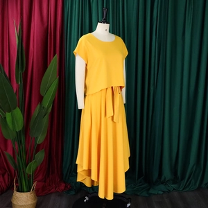 Detail of plus size ginger two-piece set featuring a cropped top and asymmetrical skirt