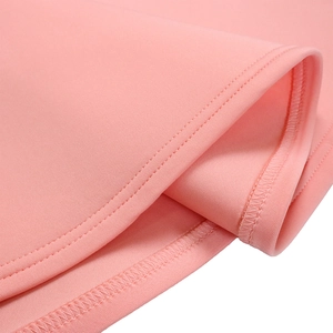 Macro detail of high-quality double-stitched hem and pink fabric texture on evening dress