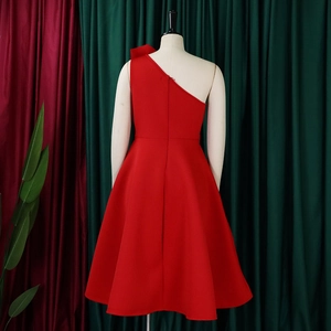 Detail of elegant red one-shoulder evening dress with pleated bodice and A-line silhouette