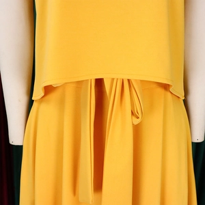 Detail of plus size bright yellow outfit showing waist tie and high-quality fabric texture