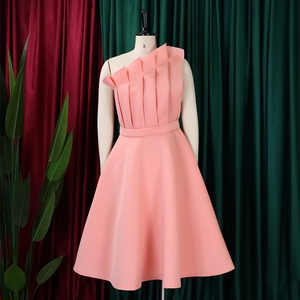 Detailed view of asymmetric one-shoulder design with pleated fabric on a pink dress