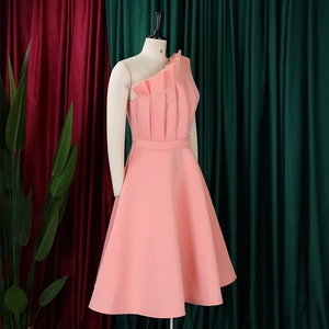 Macro detail of asymmetric ruffled neckline on peach pink one-shoulder evening gown