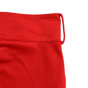 Detailed macro view of red knitted fabric with neat seams and waist belt loop detail