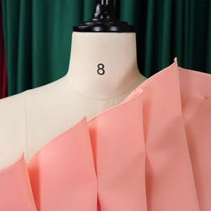 Detail of pink tiered ruffled layers and fine overlock stitching on formal dress