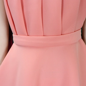 Close-up of pink pleated dress waist with wide matching belt and textured chiffon fabric