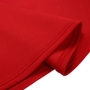 Close-up of red knit dress showing double-line stitching and premium fabric texture