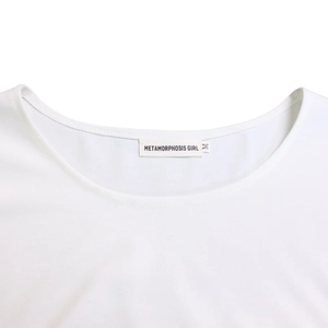 Detail shot of white crew neck T-shirt neckline with Metamorphosis Girl brand label