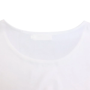 Detail of round neckline and precise stitching on a white plus-size elegant top