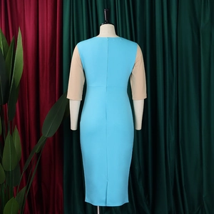 Detail view of sky blue bodycon dress with beige sleeves, back slit and hidden zipper