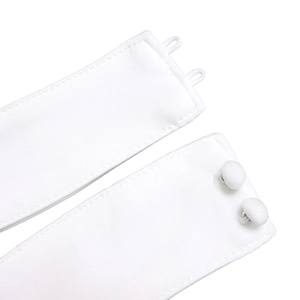 Detail of white fabric strap with matching covered buttons and elastic loops on summer outfit