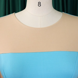 Detailed view of the round neckline on the beige and blue color-block plus size dress