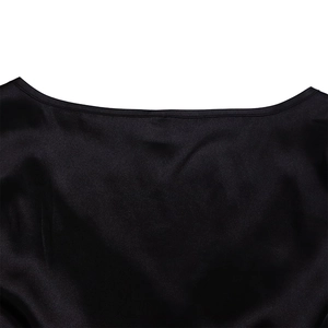Macro view of black satin dress neckline showing fine stitching and glossy fabric texture