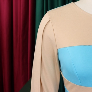 Detail shot of the khaki and sky blue color-block dress fabric and sleeve stitching