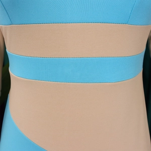 Macro view of blue and beige ribbed knit fabric showing stitching detail and elasticity