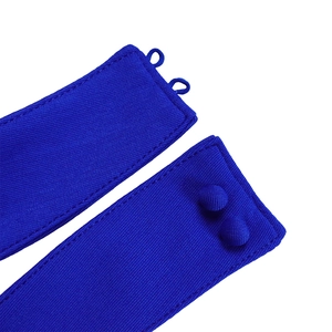 Macro shot of royal blue fabric featuring cloth-covered buttons and fine twill texture