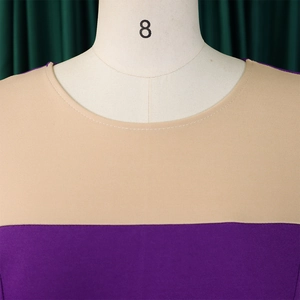 Close-up of crew neckline with contrast stitching on a two-tone plus size bodycon dress