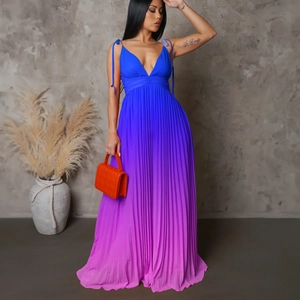 Close-up of pleated gradient fabric flowing from royal blue to bright purple on long dress