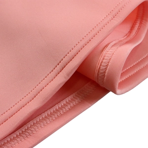 Close-up of pink peach evening dress fabric showing high-quality double-needle stitching
