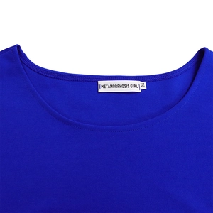 Detailed close-up of blue knit top neckline with fine double-needle stitching and logo label