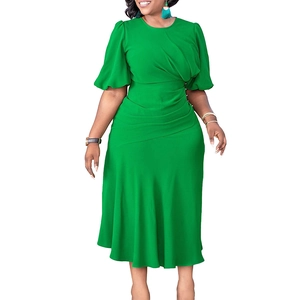 Close-up of bright green elegant dress featuring ruffled sleeves and pleated waist details