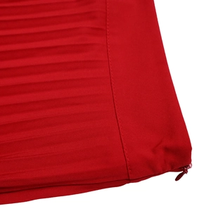 Detail view of red pleated trousers featuring a high-quality hidden side zipper