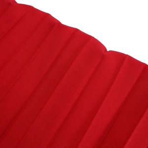 Detail of red sleeveless top fabric featuring textured three-dimensional ribbed pattern