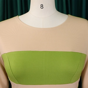 Close-up of color-block crewneck dress with textured beige and lime green panels