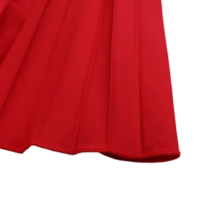 Close-up detail of red pleated fabric with neat sunray pleats and fine edge stitching